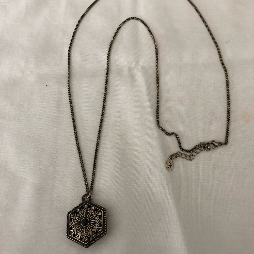 A long brushed brass colored necklace